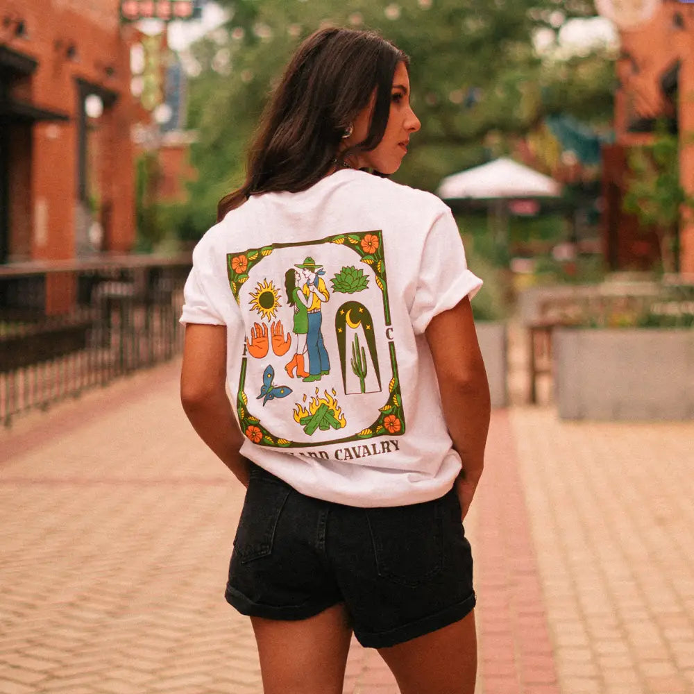 White t-shirt with a colorful nature-themed design on the back.
