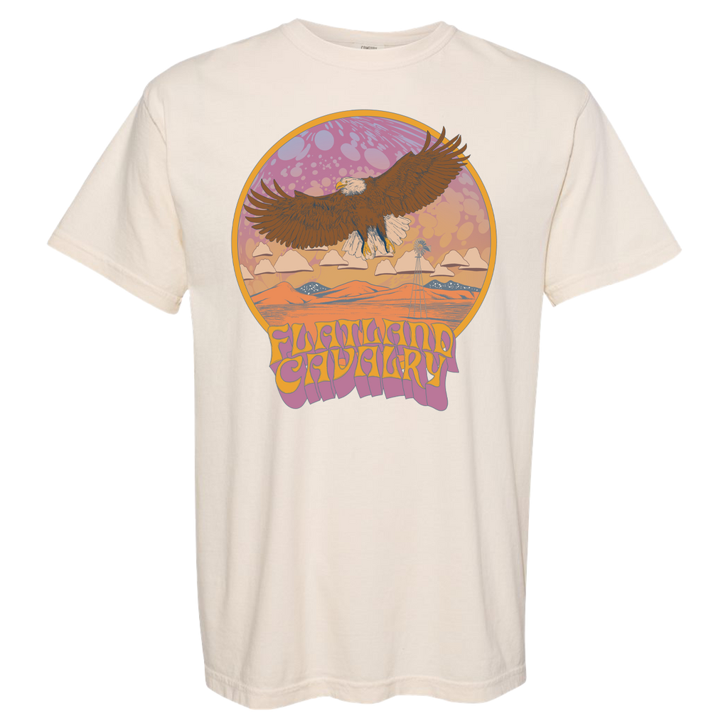 Cream-colored t-shirt featuring a retro-style graphic of an eagle soaring over a desert landscape.