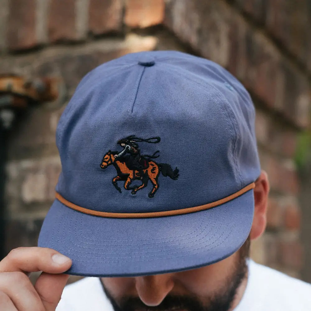 Light blue baseball cap with an embroidered horse and rider logo.