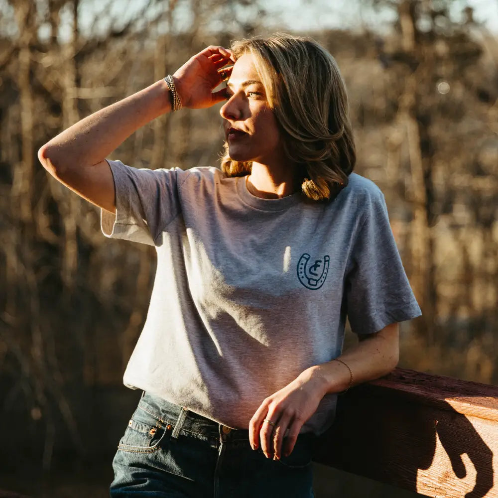 Gray t-shirt with horseshoe logo.