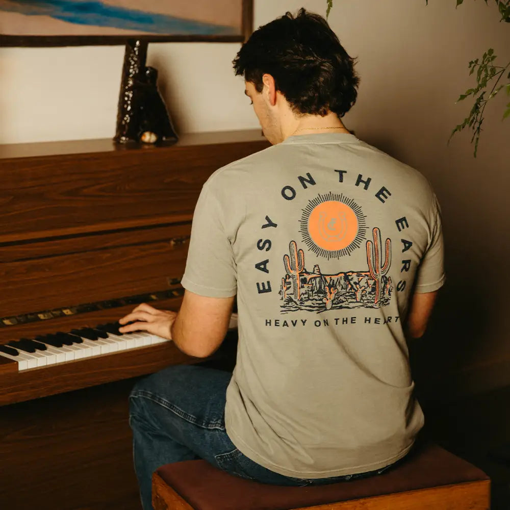 Olive green t-shirt with desert graphic.